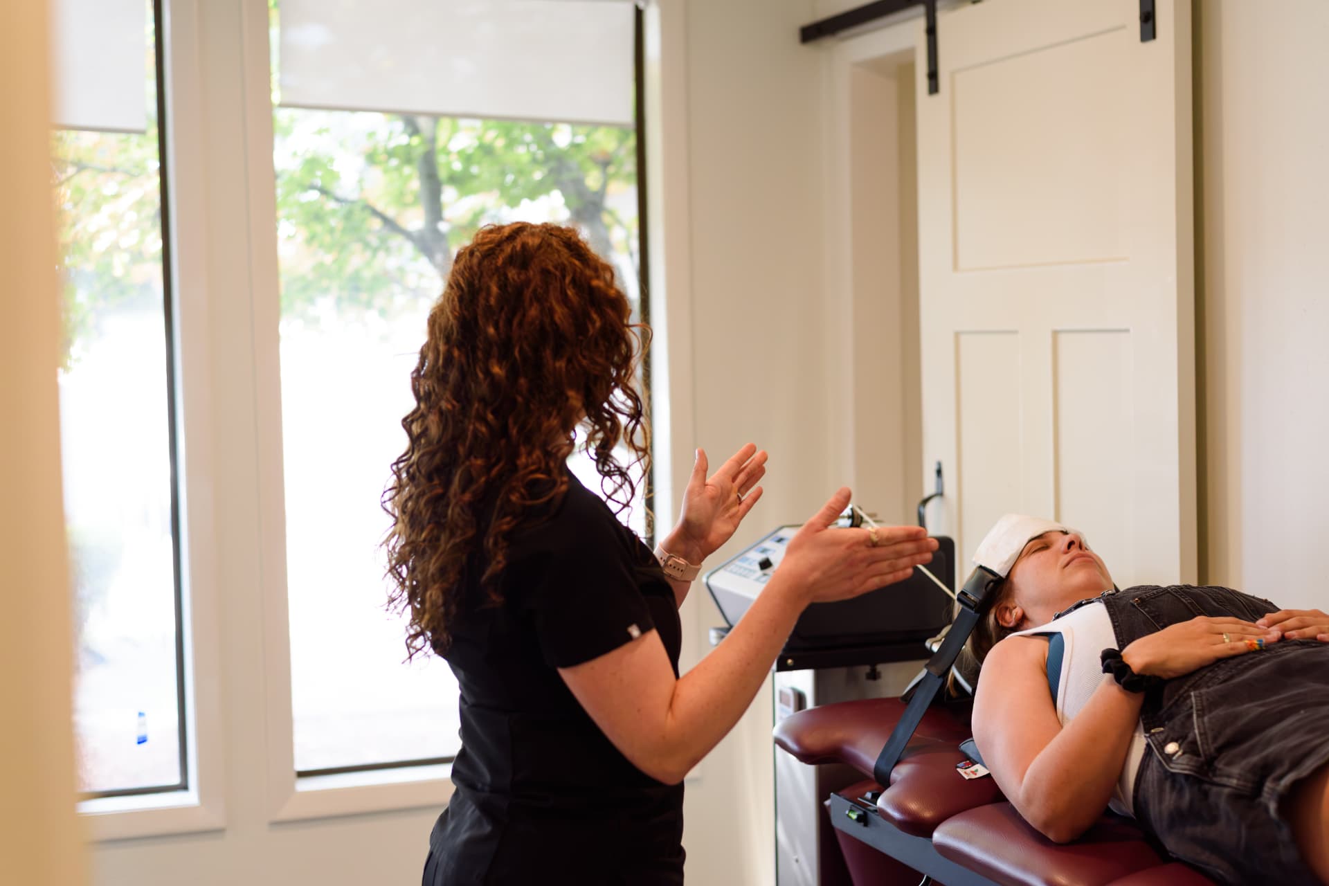 Elevation Spine Center clinician explaining cervical decompression treatment to a patient in Bend